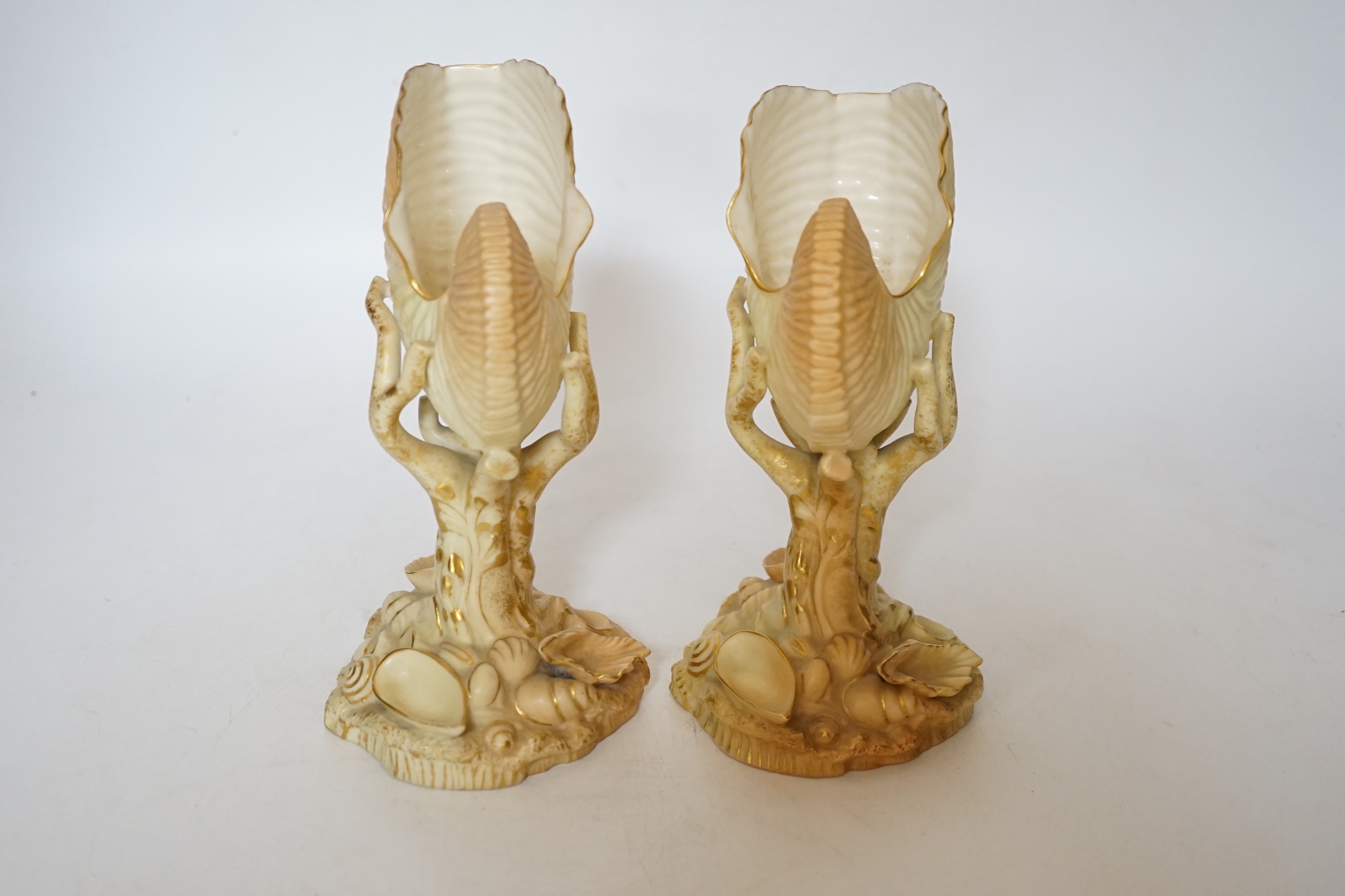A pair of Royal Worcester blush ivory nautilus shell spill vases, 17cm